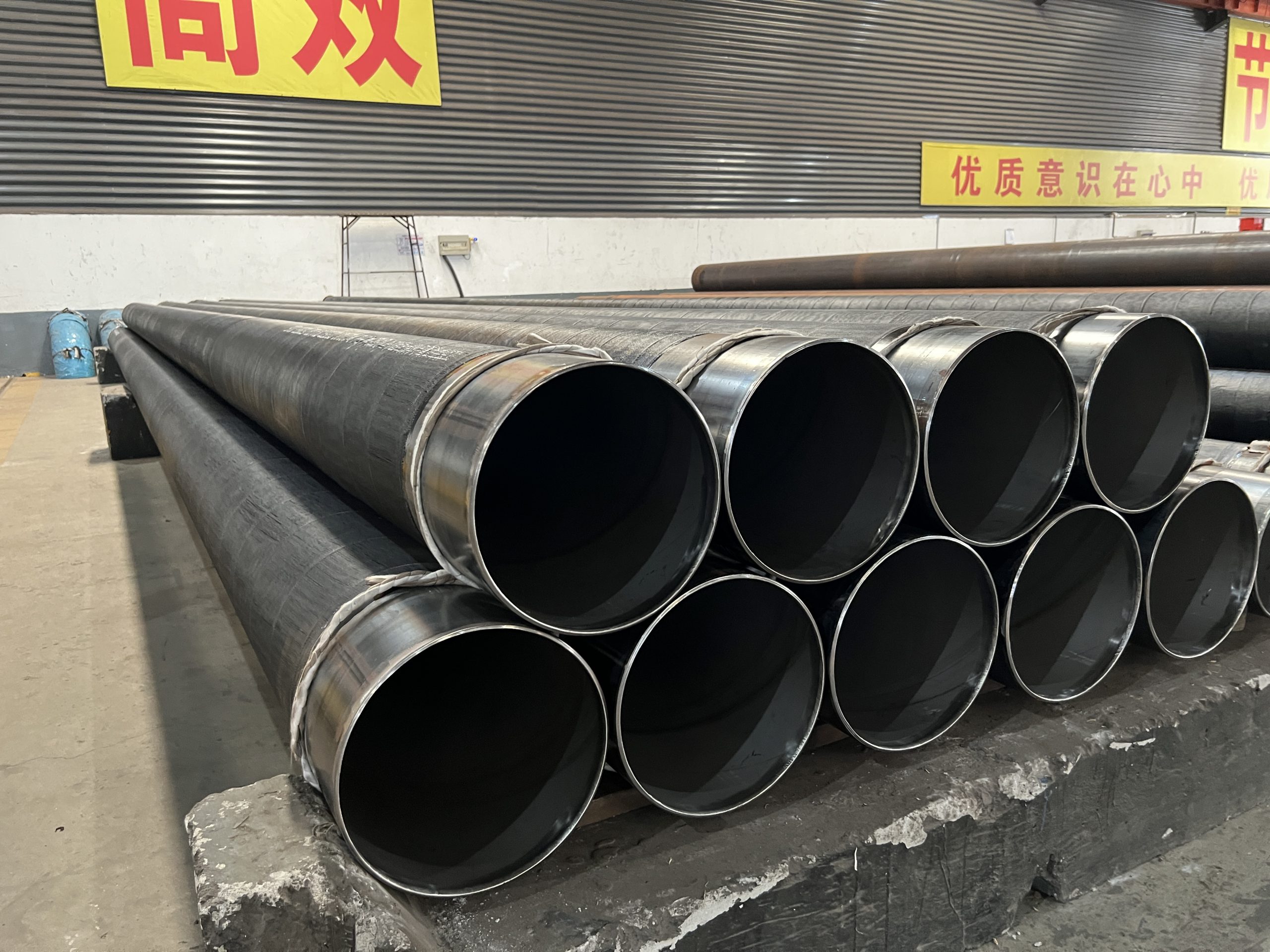 CRA clad and coated large-diameter pipe stock