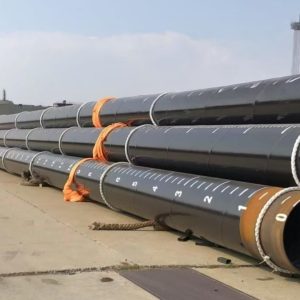 Coated steel pipes stacked in an outdoor pipe yard